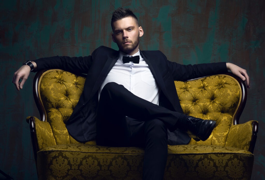 Stylish young man in a suit and bow tie. Business style.